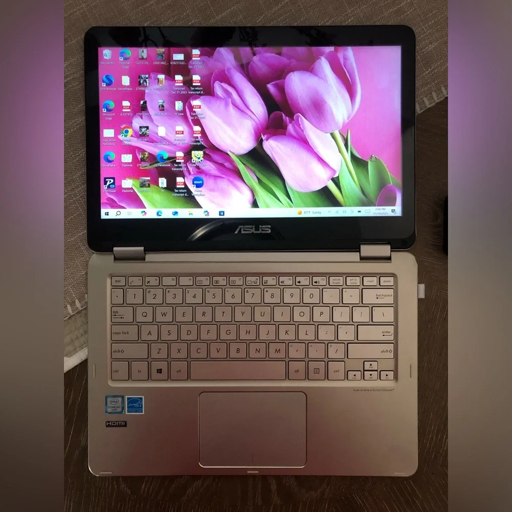 ASUS Metallic Silver Convertible Laptop with a wireless mouse and a charger.